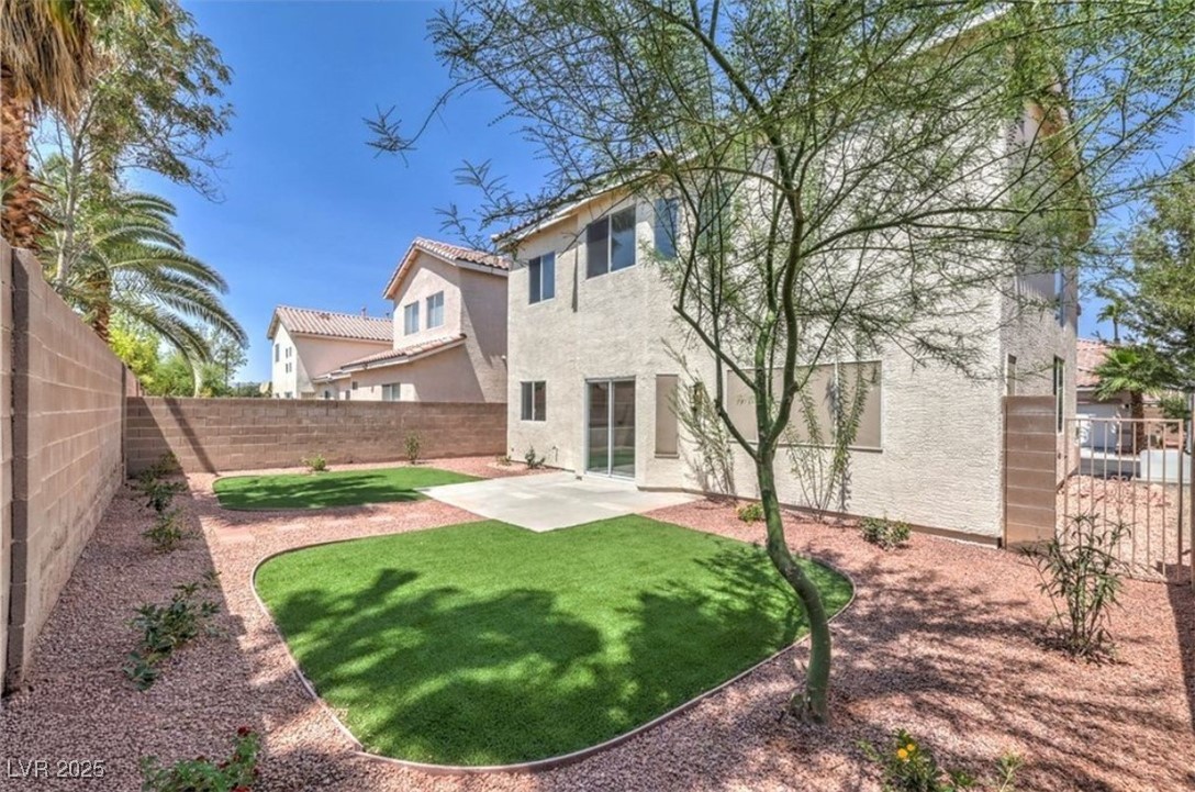 979 Park Bridge Avenue Las Vegas, NV 89123 - Photo 38 of 57 Rear view of house with a patio area, a fenced backyard, stucco siding, and a tiled roof