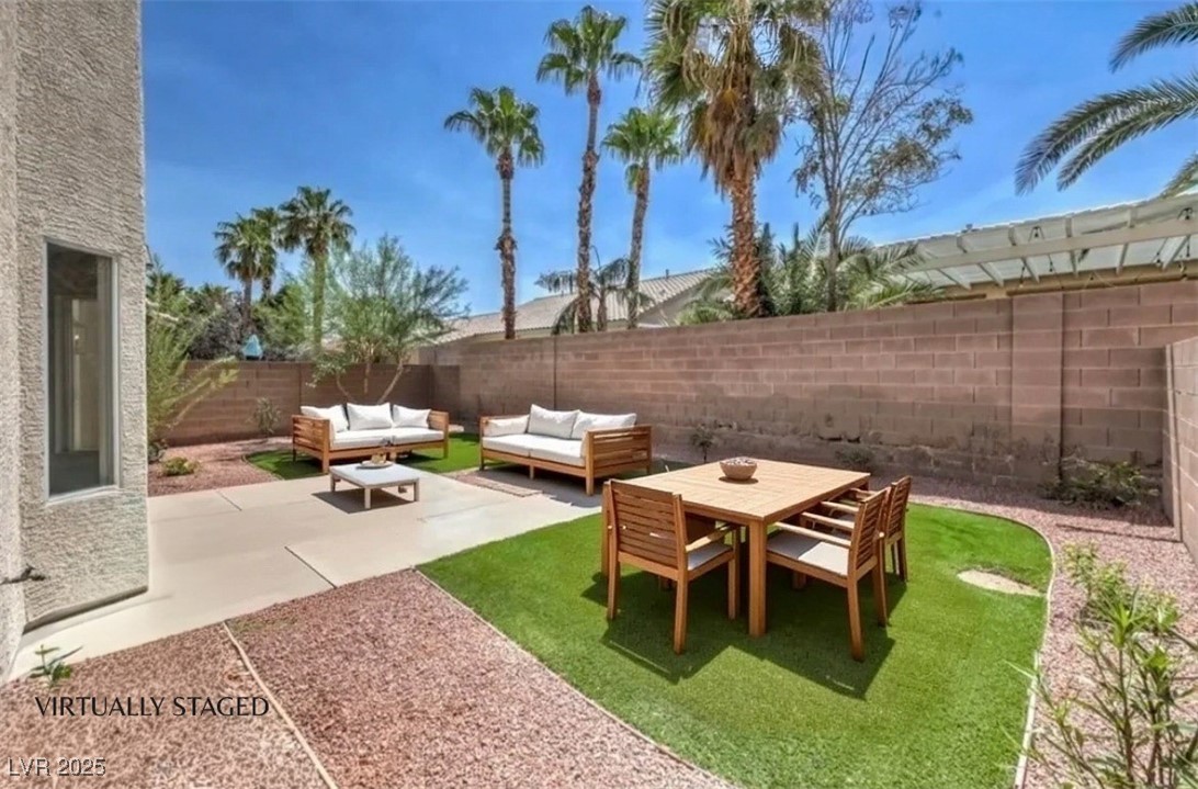 979 Park Bridge Avenue Las Vegas, NV 89123 - Photo 40 of 57 Fenced backyard with a patio area and an outdoor hangout area
