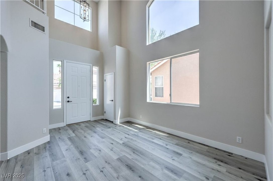 979 Park Bridge Avenue Las Vegas, NV 89123 - Photo 6 of 57 Entryway featuring a towering ceiling and light wood finished floors
