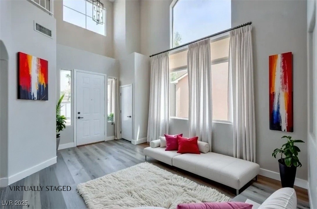 979 Park Bridge Avenue Las Vegas, NV 89123 - Photo 7 of 57 Foyer entrance featuring wood finished floors and a towering ceiling