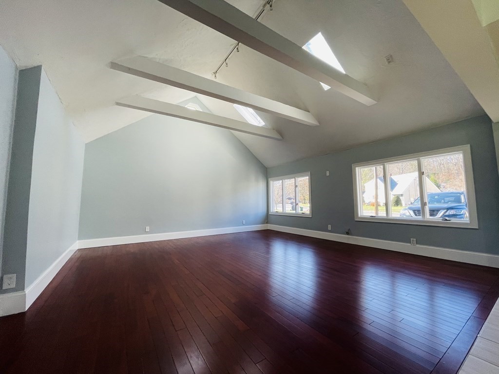 11 Hardwick Road Natick, MA 01760 - Photo 2 of 16 an empty room with wooden floor and windows