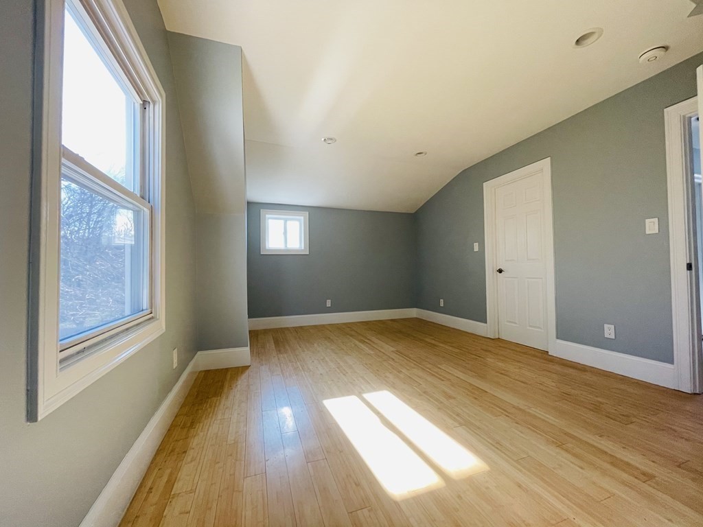 11 Hardwick Road Natick, MA 01760 - Photo 4 of 16 a view of empty room with wooden floor and fan