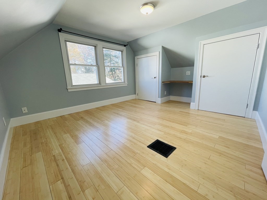 11 Hardwick Road Natick, MA 01760 - Photo 5 of 16 an empty room with wooden floor and windows