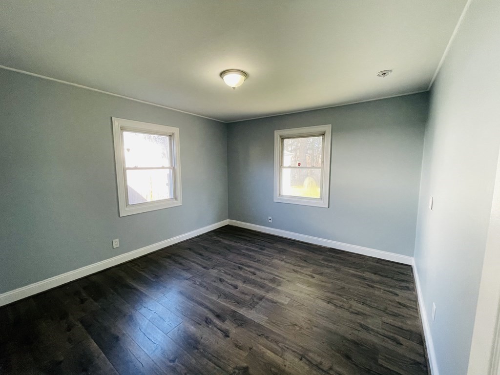 11 Hardwick Road Natick, MA 01760 - Photo 6 of 16 an empty room with wooden floor and windows