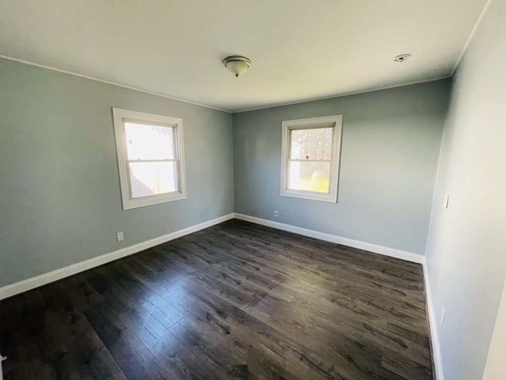 11 Hardwick Road Natick, MA 01760 - Photo 7 of 16 an empty room with wooden floor and windows