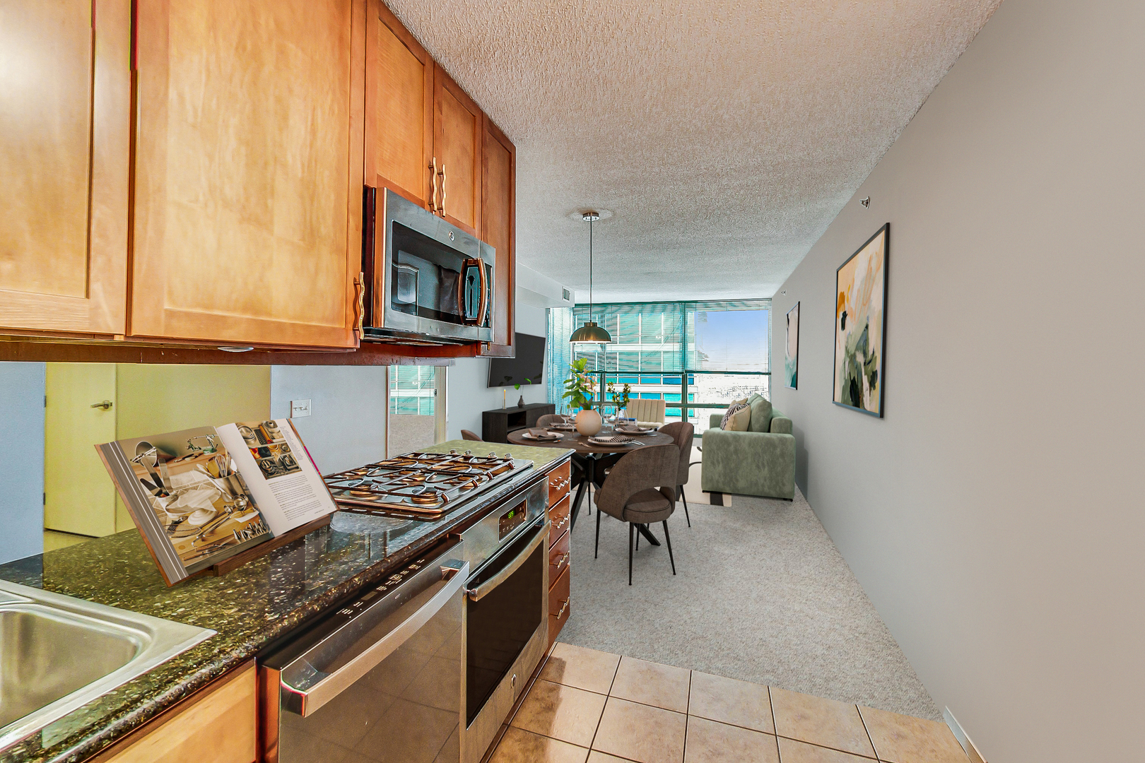 9655 Woods Drive, Unit 1405 Skokie, IL 60077 - Photo 14 of 36 a kitchen with furniture a stove a sink and a microwave