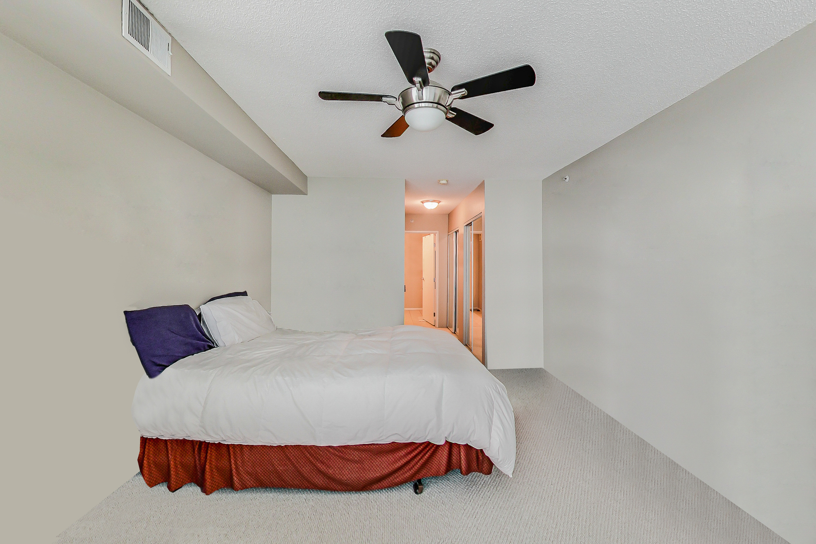 9655 Woods Drive, Unit 1405 Skokie, IL 60077 - Photo 17 of 36 a bedroom with a bed and ceiling fan