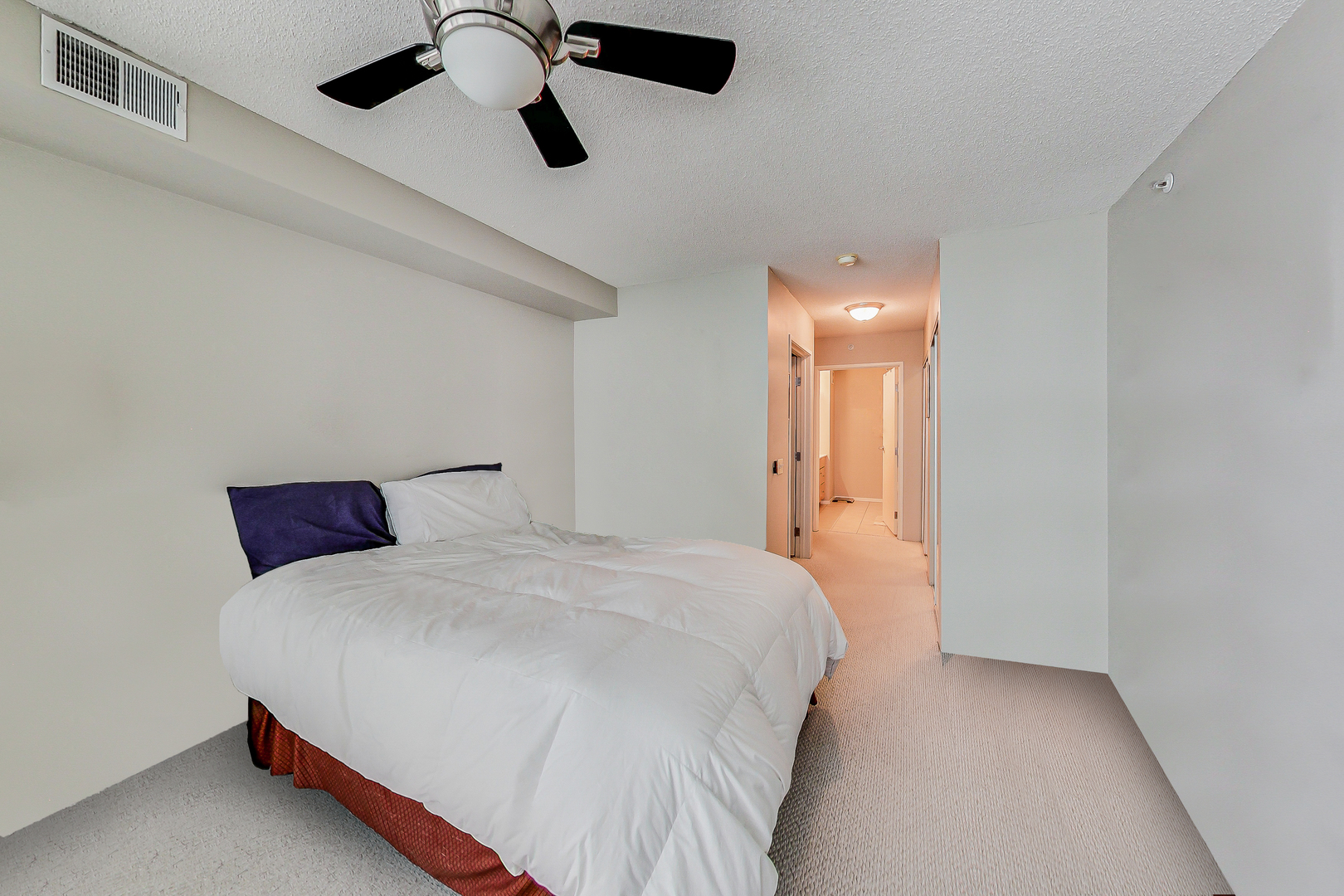 9655 Woods Drive, Unit 1405 Skokie, IL 60077 - Photo 18 of 36 a bedroom with a bed and cabinets