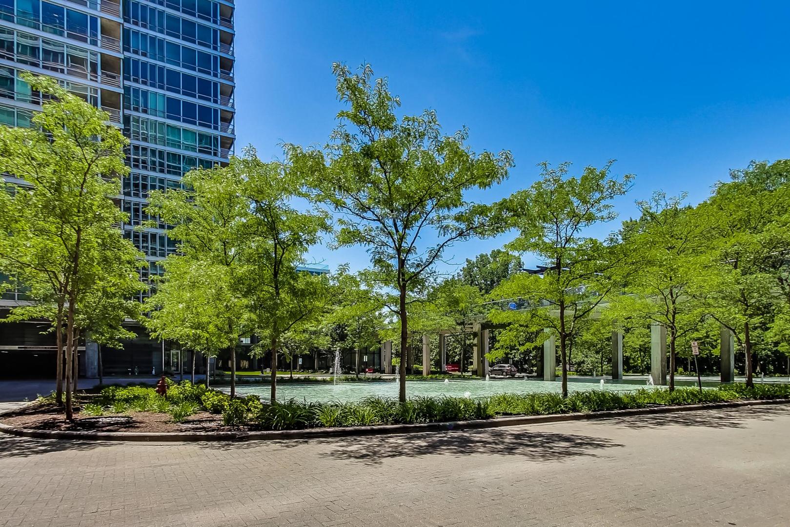 9655 Woods Drive, Unit 1405 Skokie, IL 60077 - Photo 35 of 36 a view of a parked cars in front of a building