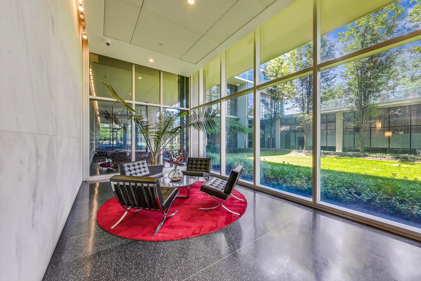 9655 Woods Drive, Unit 1405 Skokie, IL 60077 - Photo 5 of 36 a view of swimming pool with a living room and floor to ceiling window