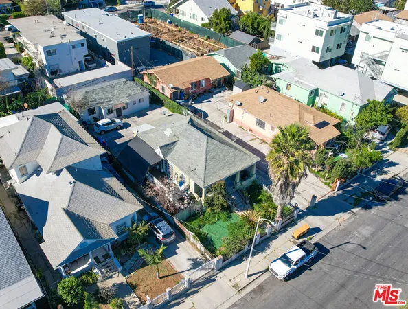 an aerial view of multiple houses with yard