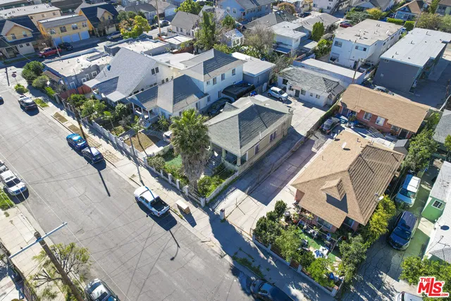 an aerial view of residential houses with green space