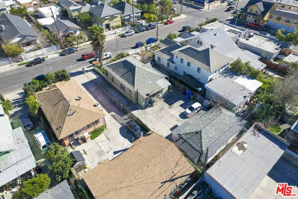 an aerial view of multiple houses with yard