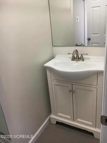 a bathroom with a sink and mirror