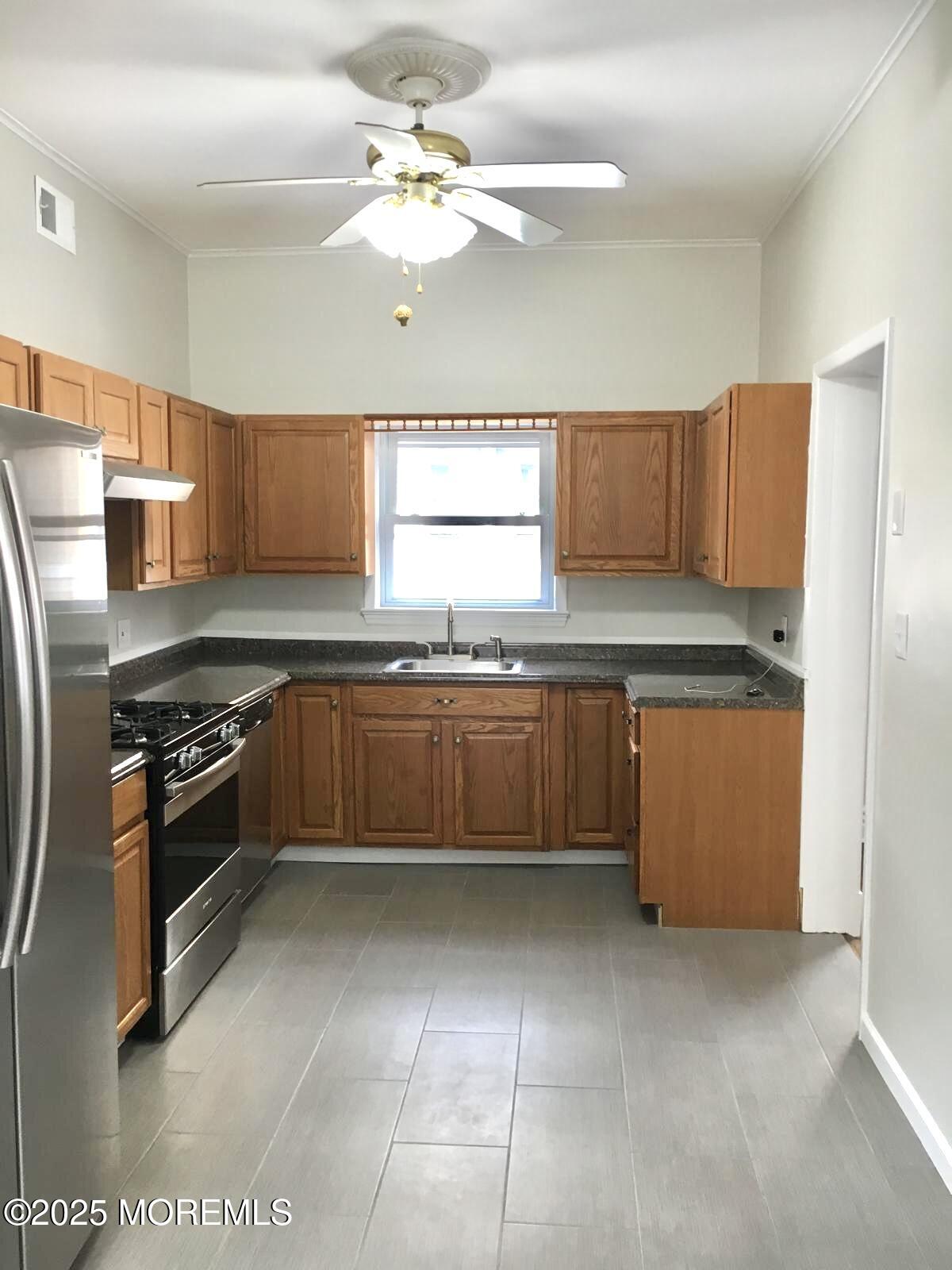 32 Morrell Street Long Branch, NJ 07740 - Photo 5 of 14 a kitchen with stainless steel appliances granite countertop a stove a sink and a refrigerator