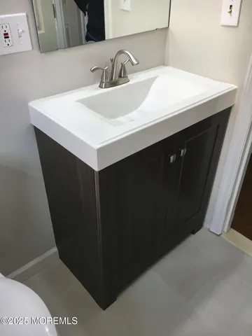 a close up of a sink and a mirror