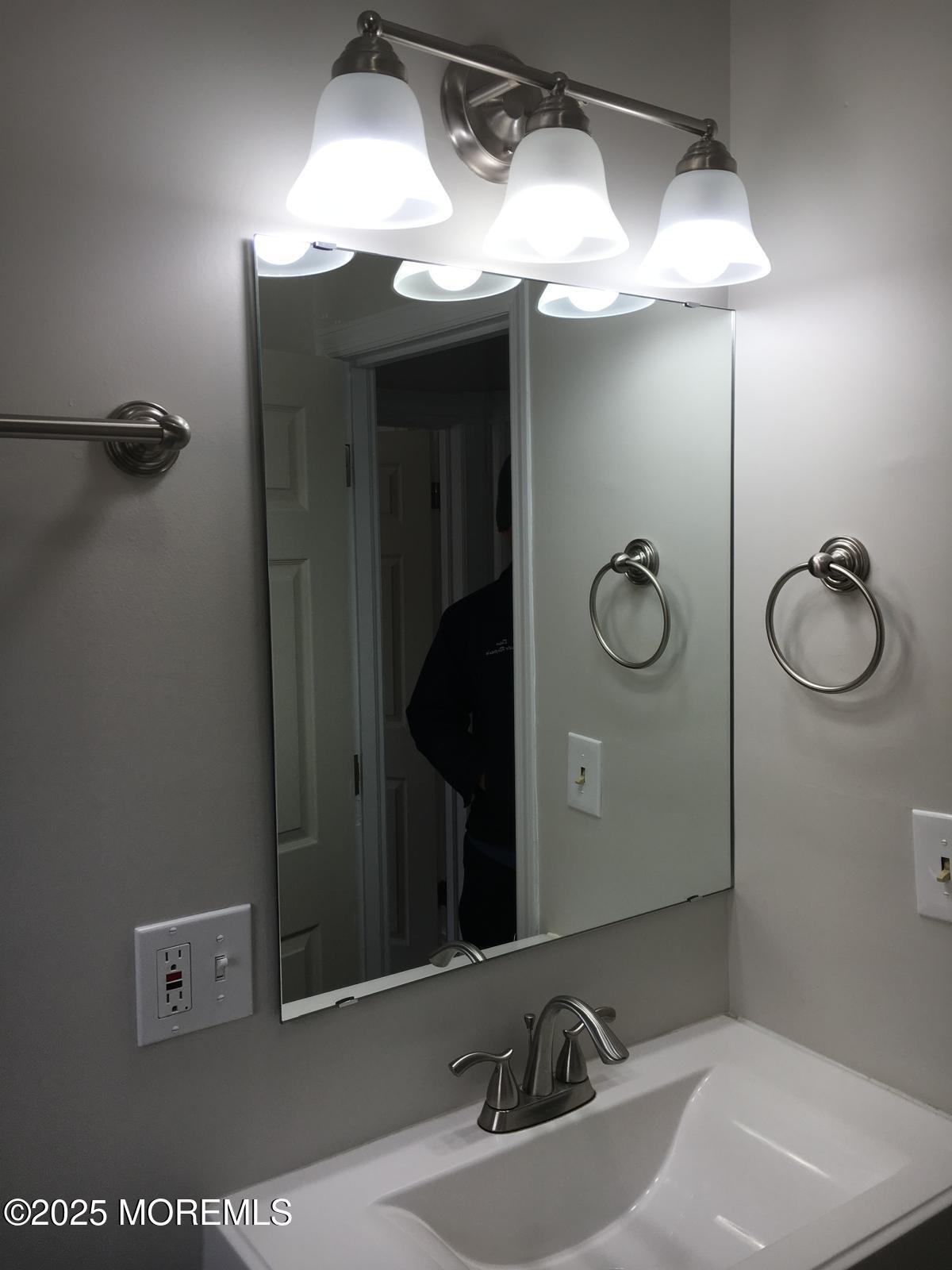 32 Morrell Street Long Branch, NJ 07740 - Photo 10 of 14 a bathroom with a sink and mirror