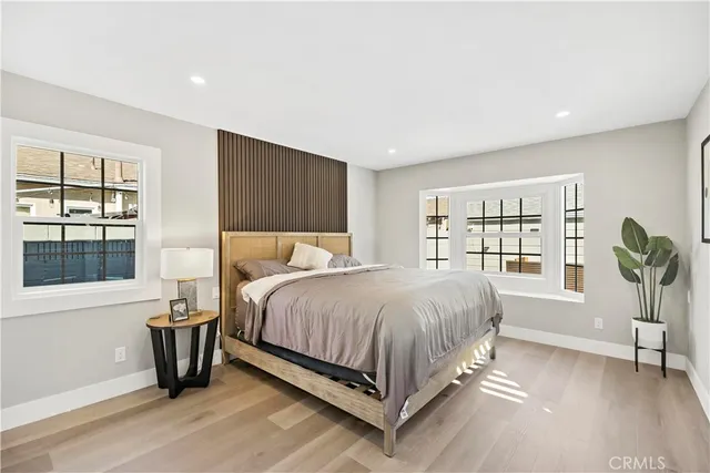 a bedroom with a large bed and a window