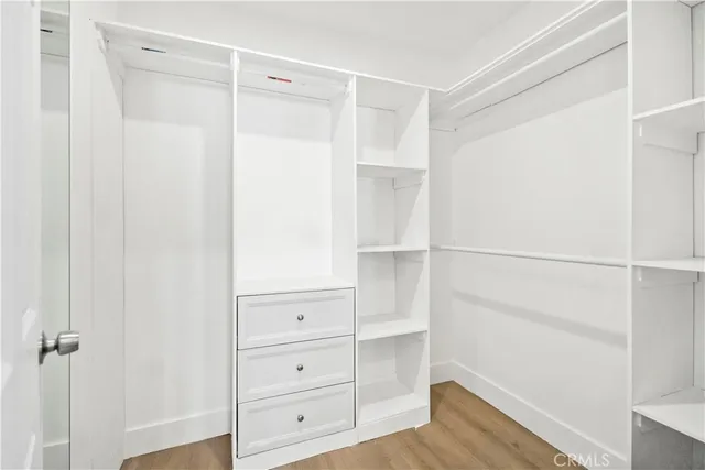 a view of walk in closet with empty racks