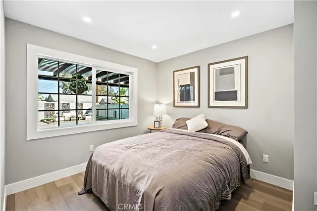 a large bed sitting in a bedroom next to a window