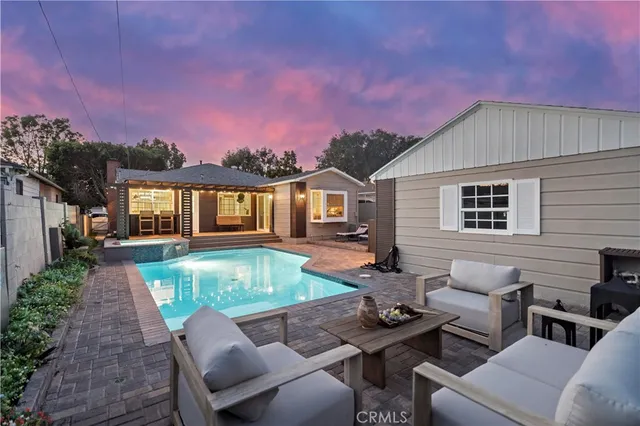 a backyard of a house with seating space and a potted plants