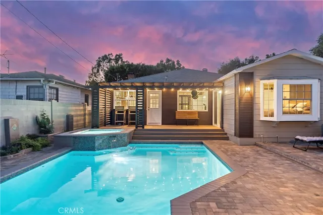 a view of a house with backyard porch and sitting area