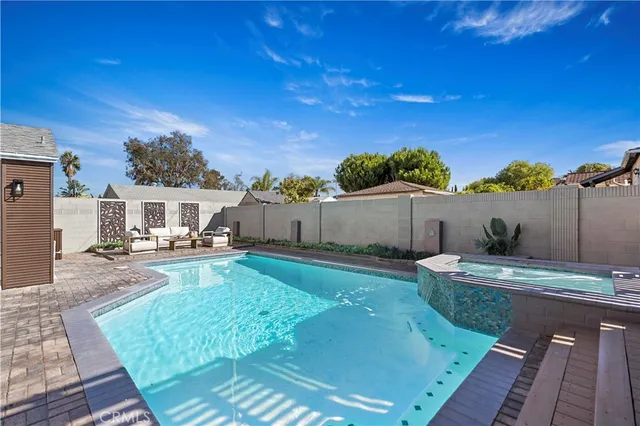 a view of a backyard with sitting area