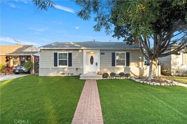 a front view of a house with a garden