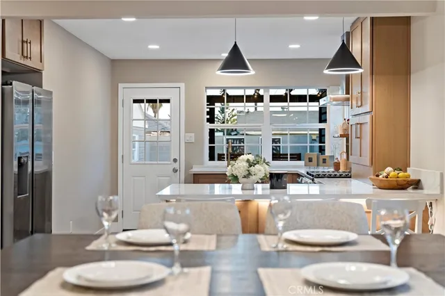 a kitchen with a dining table and chairs