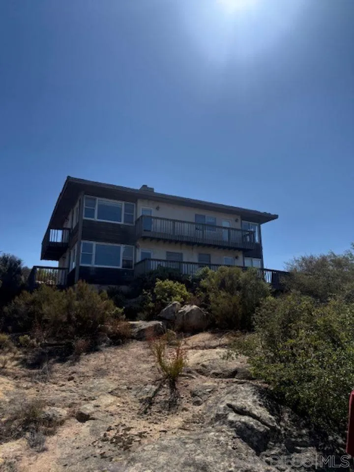 6402 Japatul Highlands Road Alpine, CA 91901 - Photo 2 of 4 a backyard of a house with lots of green space