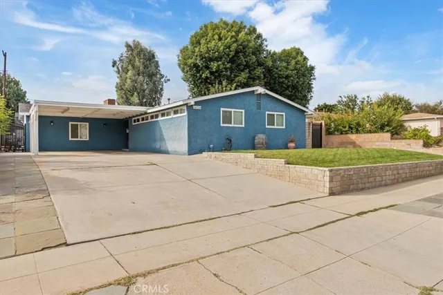 a house that has a tree in front of it