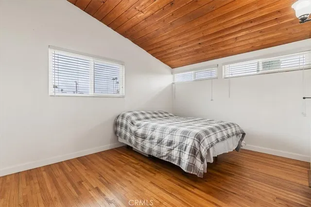 a bedroom with a bed and a fan in it