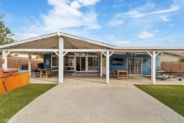 a view of a house with backyard porch and furniture