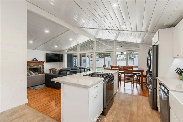 a kitchen with appliances a sink a counter top space and cabinets