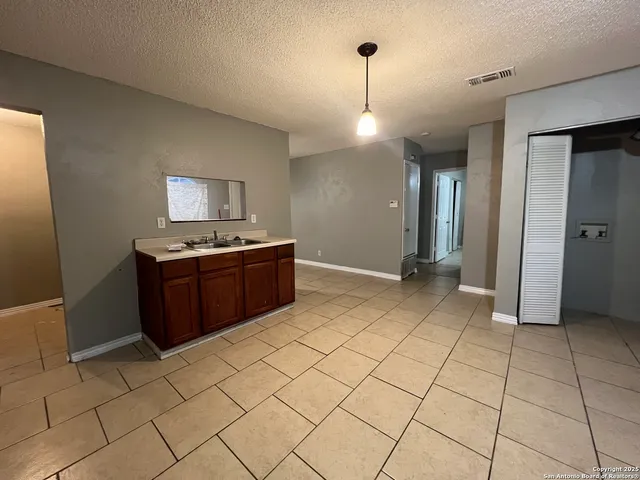 a open kitchen with cabinets and stainless steel appliances