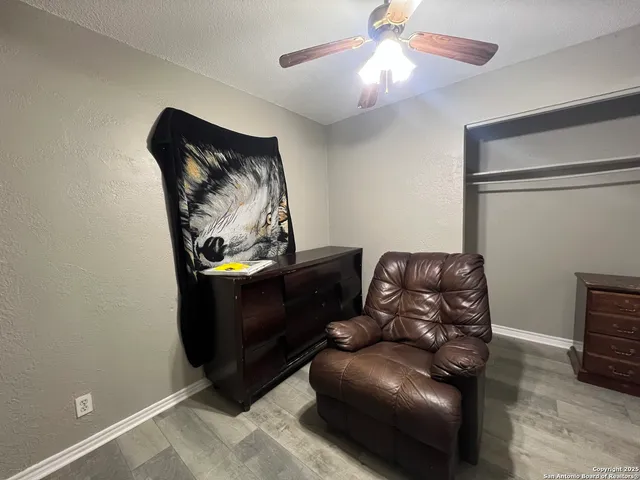 a living room with furniture and a lamp