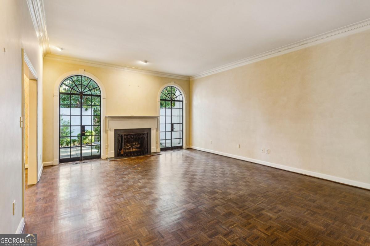19 Mooregate Square Northwest Atlanta, GA 30327 - Photo 11 of 48 a view of an empty room with a fireplace and a window