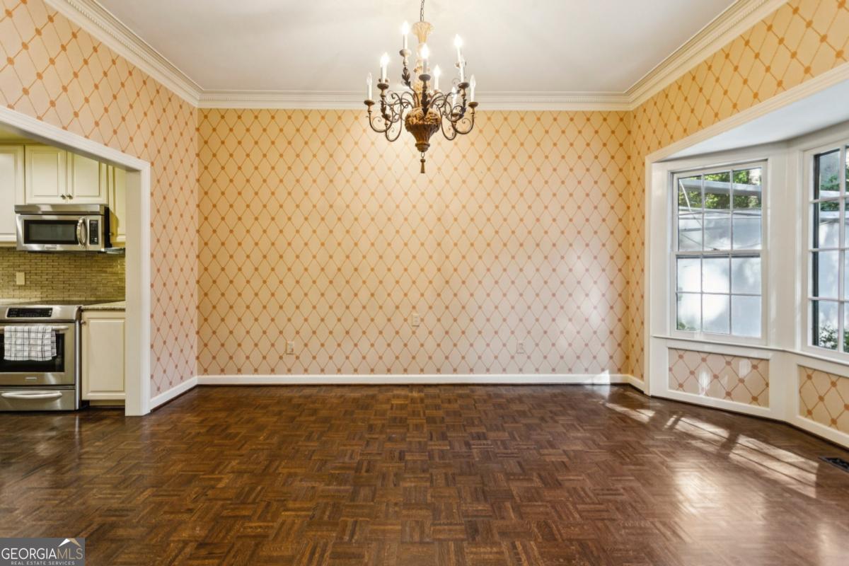 19 Mooregate Square Northwest Atlanta, GA 30327 - Photo 15 of 48 a view of a livingroom with wooden floor and a kitchen space
