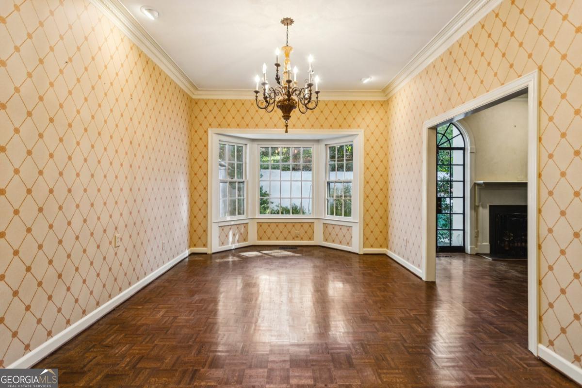 19 Mooregate Square Northwest Atlanta, GA 30327 - Photo 16 of 48 a view of an empty room with wooden floor and a window