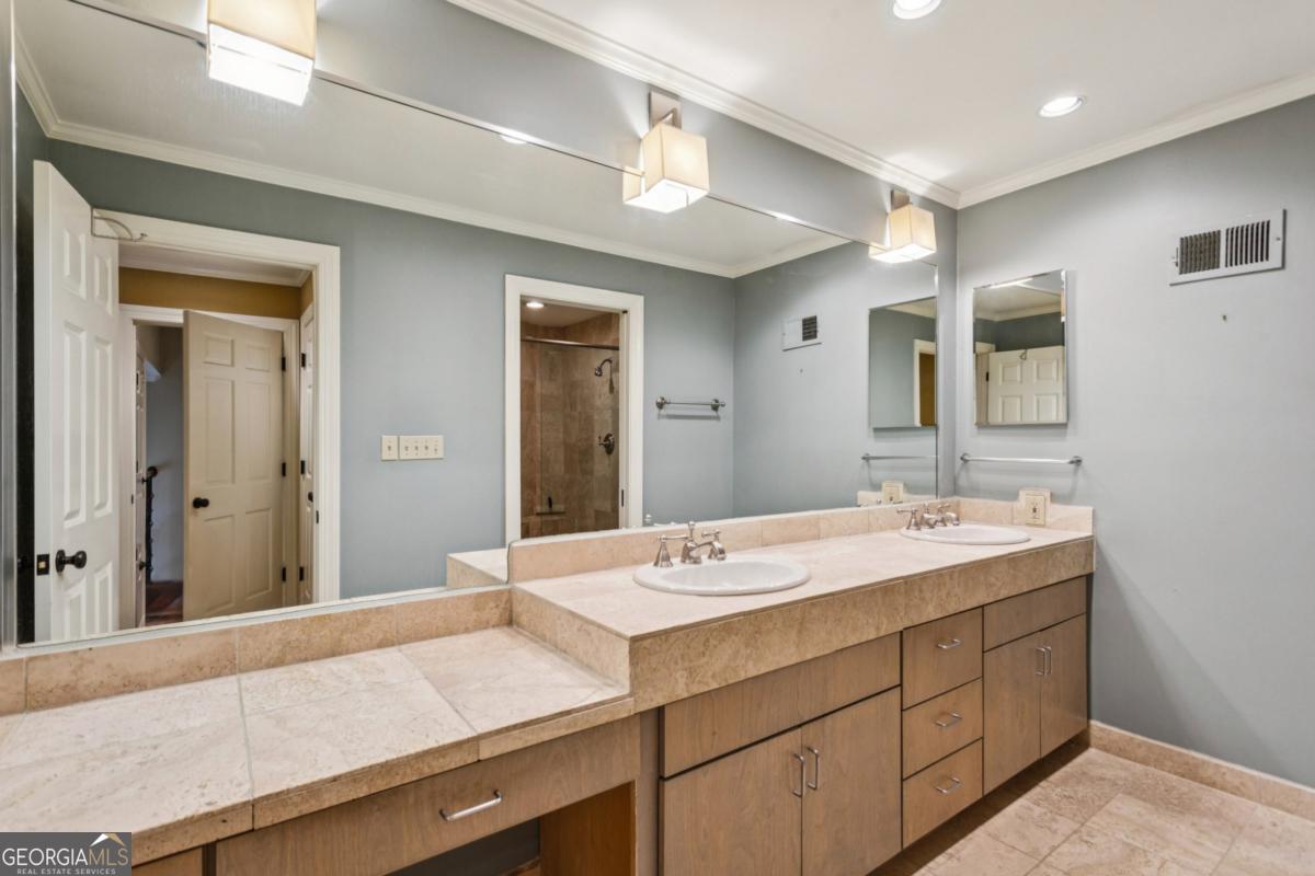 19 Mooregate Square Northwest Atlanta, GA 30327 - Photo 31 of 48 a bathroom with a sink a vanity and a mirror