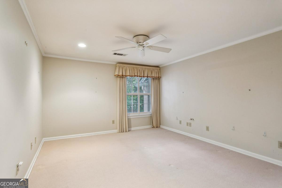 19 Mooregate Square Northwest Atlanta, GA 30327 - Photo 34 of 48 an empty room with a window and a ceiling fan