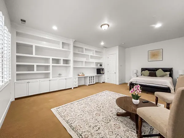 a living room with furniture and a rug