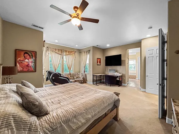 a bedroom with a bed and a flat screen tv
