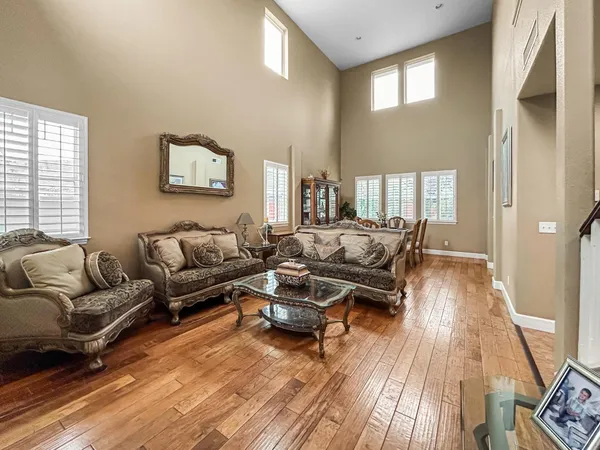 a living room with furniture and a wooden floor