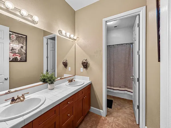 a bathroom with a double vanity sink mirror and double