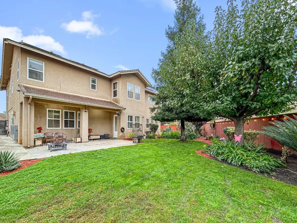 a front view of a house with a yard porch and outdoor seating