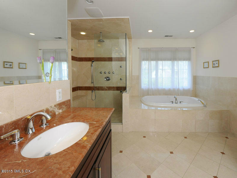 10 Tyler Lane Riverside, CT 06878 - Photo 13 of 25 a bathroom with a granite countertop sink a mirror and a bathtub