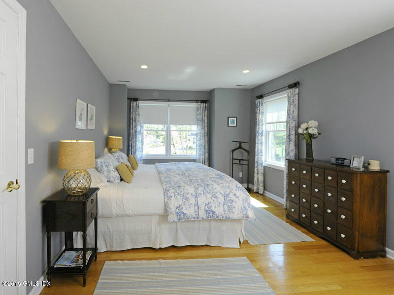 10 Tyler Lane Riverside, CT 06878 - Photo 14 of 25 a bedroom with a bed and wooden floor