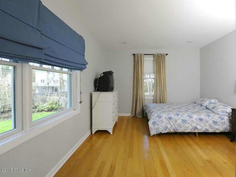 10 Tyler Lane Riverside, CT 06878 - Photo 18 of 25 a bedroom with a bed and wooden floor