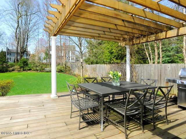 10 Tyler Lane Riverside, CT 06878 - Photo 21 of 25 a view of a patio with table and chairs under an umbrella